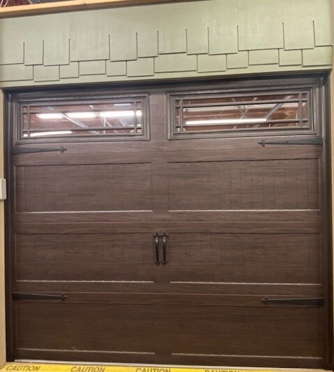 Wood color garage door with top section of windows.