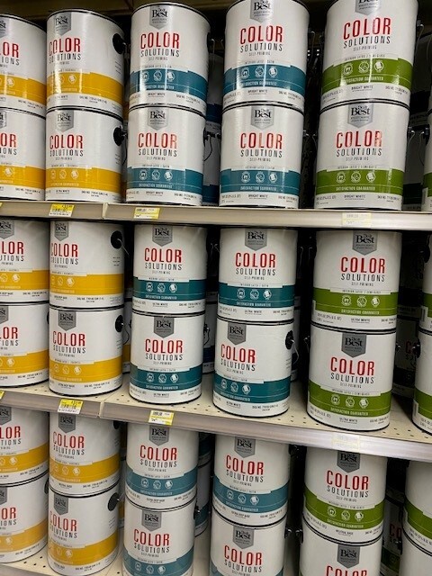 Color Solutions paint cans on shelf.